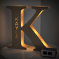 Personalized wooden letter K night light with KAYLA engraved, warm glow, 19CM, custom name lamp.